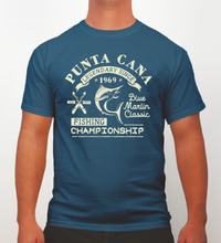 Indigo blue t-shirt with cream text ‘Punta Cana Fishing Championship Blue Marlin Classic’ by Hot Penguin, Ltd. on a plain background